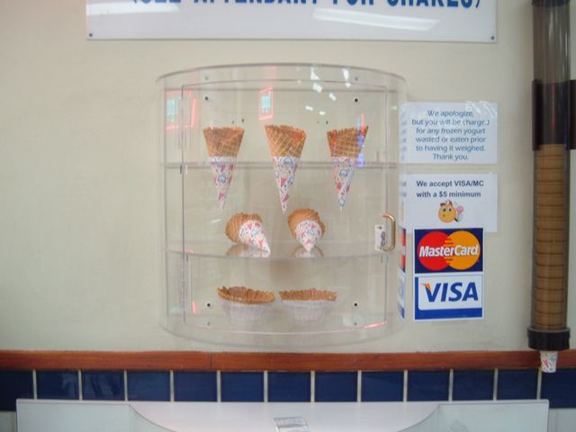 A display case with ice cream cones and a visa sign