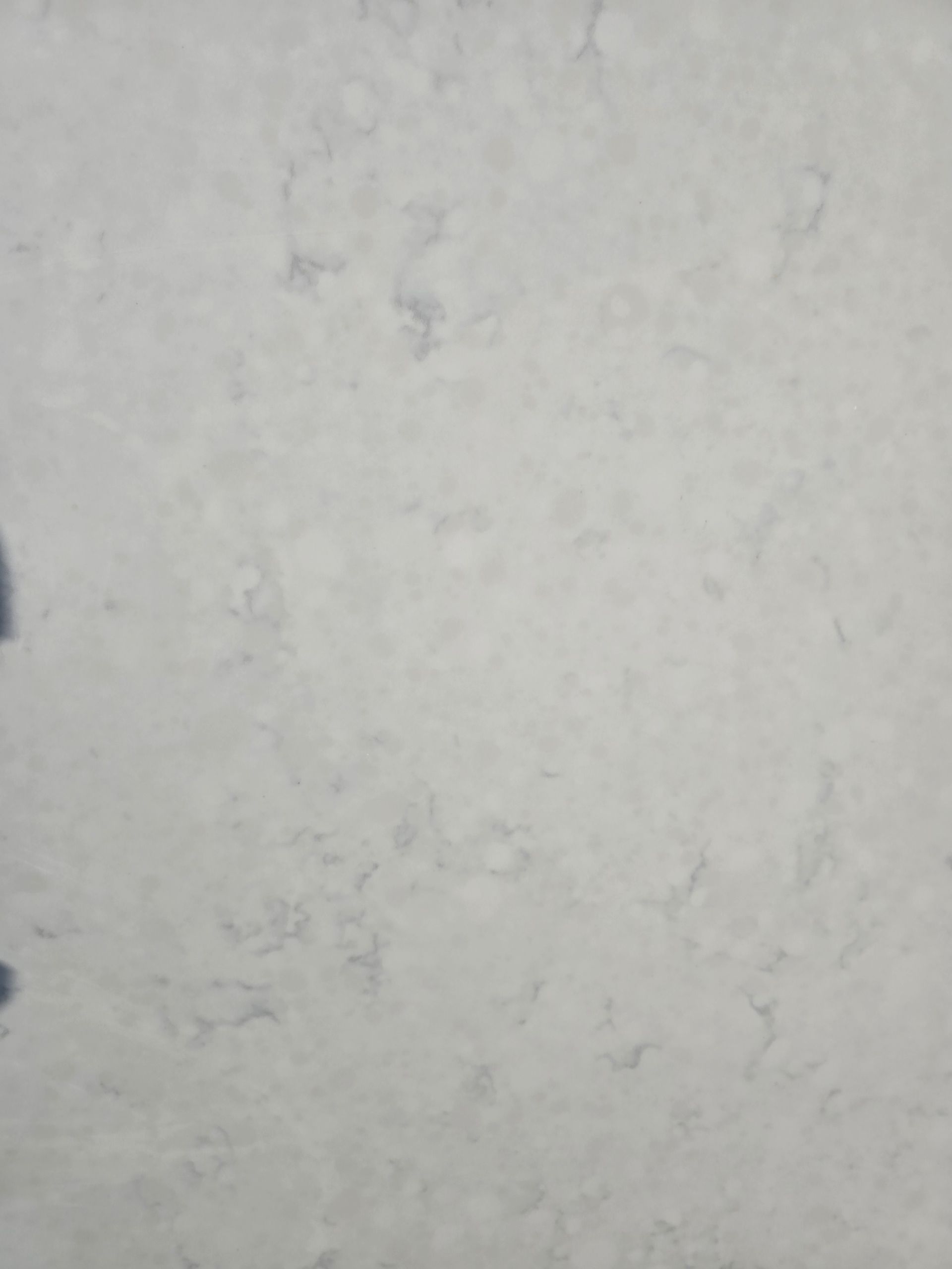 A close up of a white marble counter top.