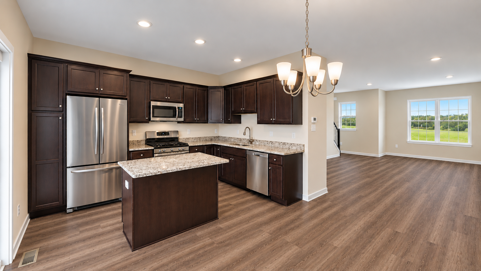Bright modern kitchen with white cabinets, stainless appliances, granite island, and sliding doors to a deck view