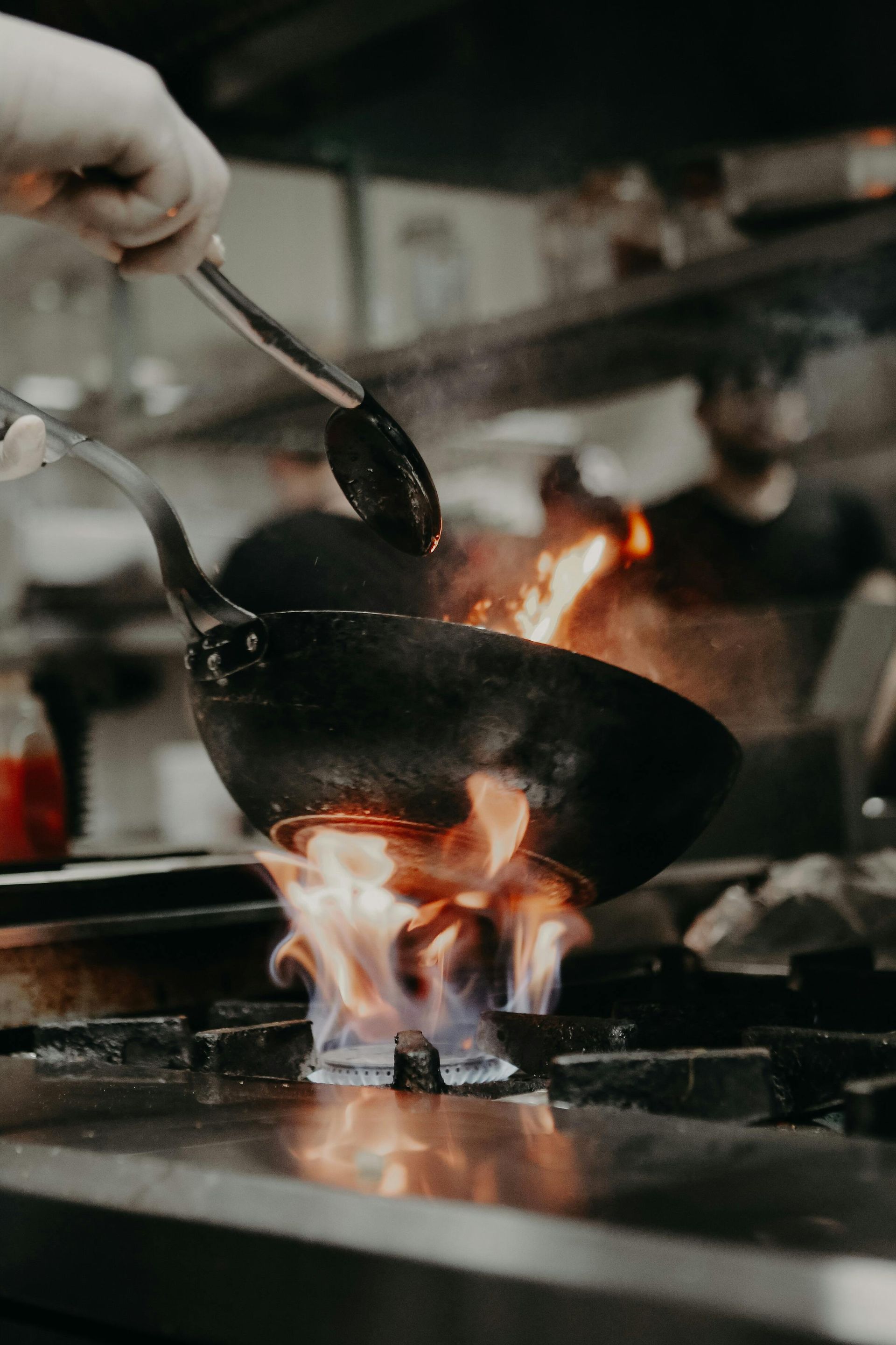 Wok Cooking with Flames Erupting — Kuranda Gas & Supplies In Koah, QLD