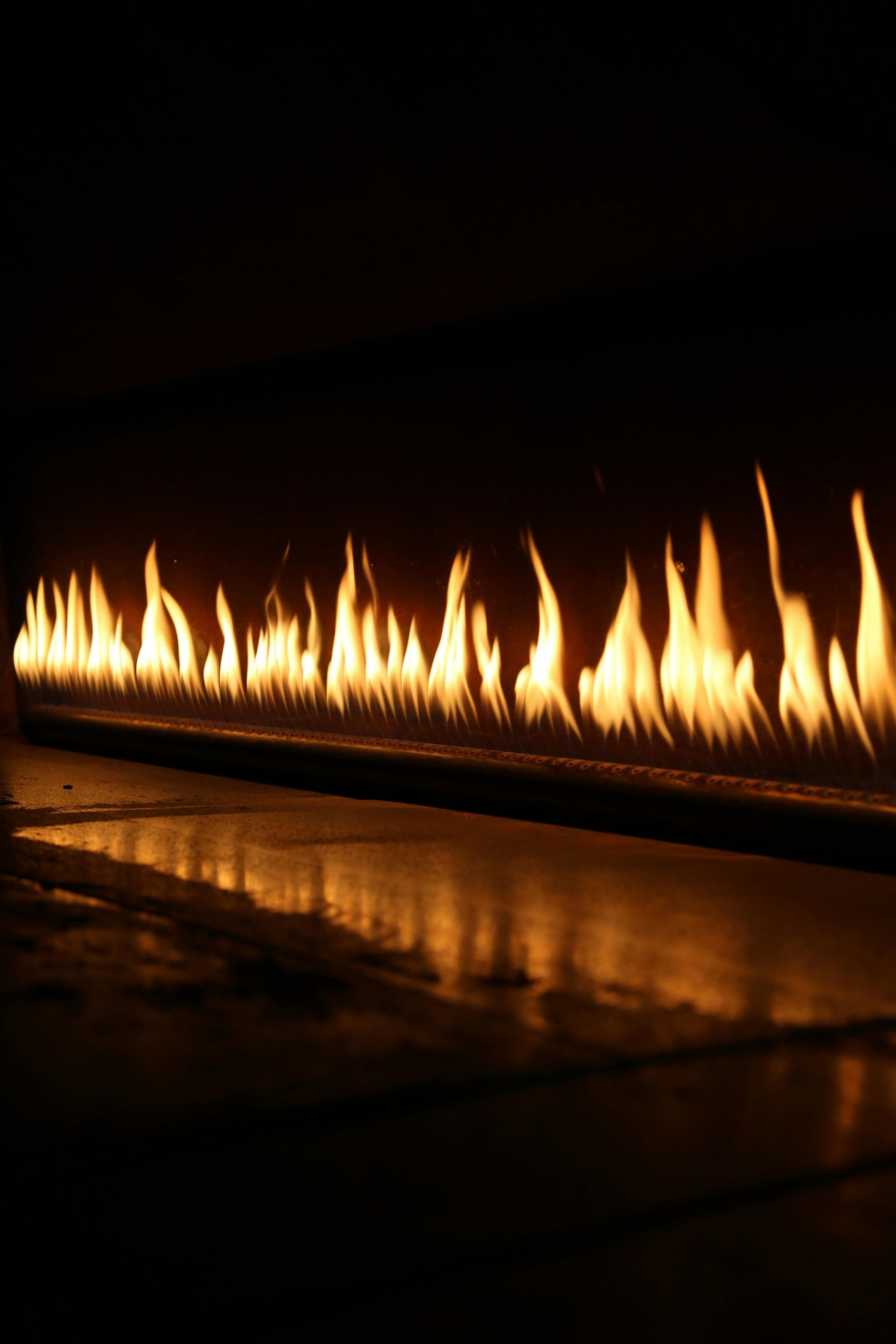 Flames of An Orange Fire Dancing in A Linear Row Against a Dark Background — Kuranda Gas & Supplies In Koah, QLD