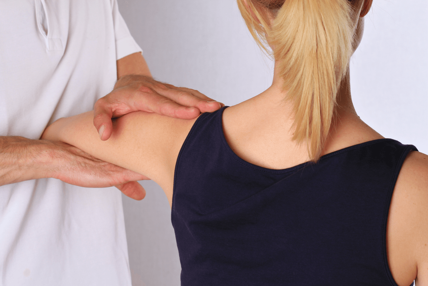 a man is giving a woman a massage on her shoulder .