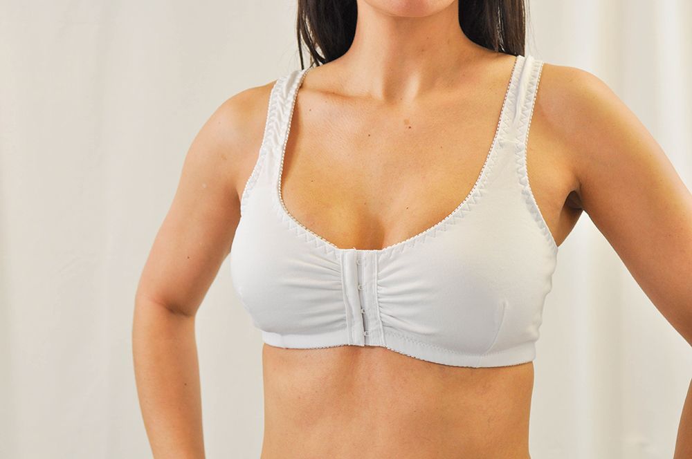 a woman is wearing a white bra with a zipper on the front .