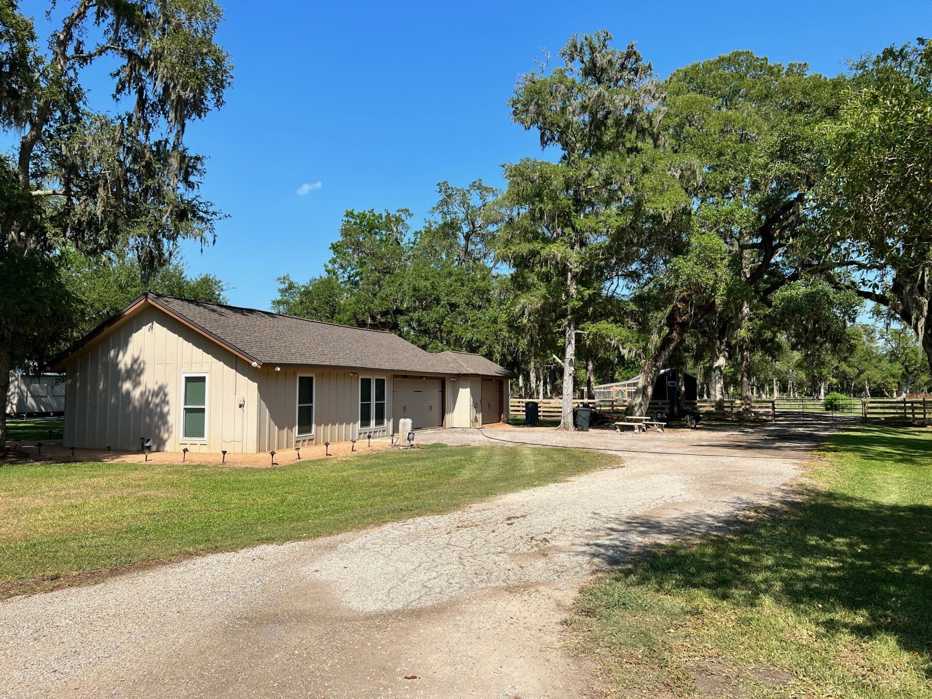 a house with a gravel driveway leading to it