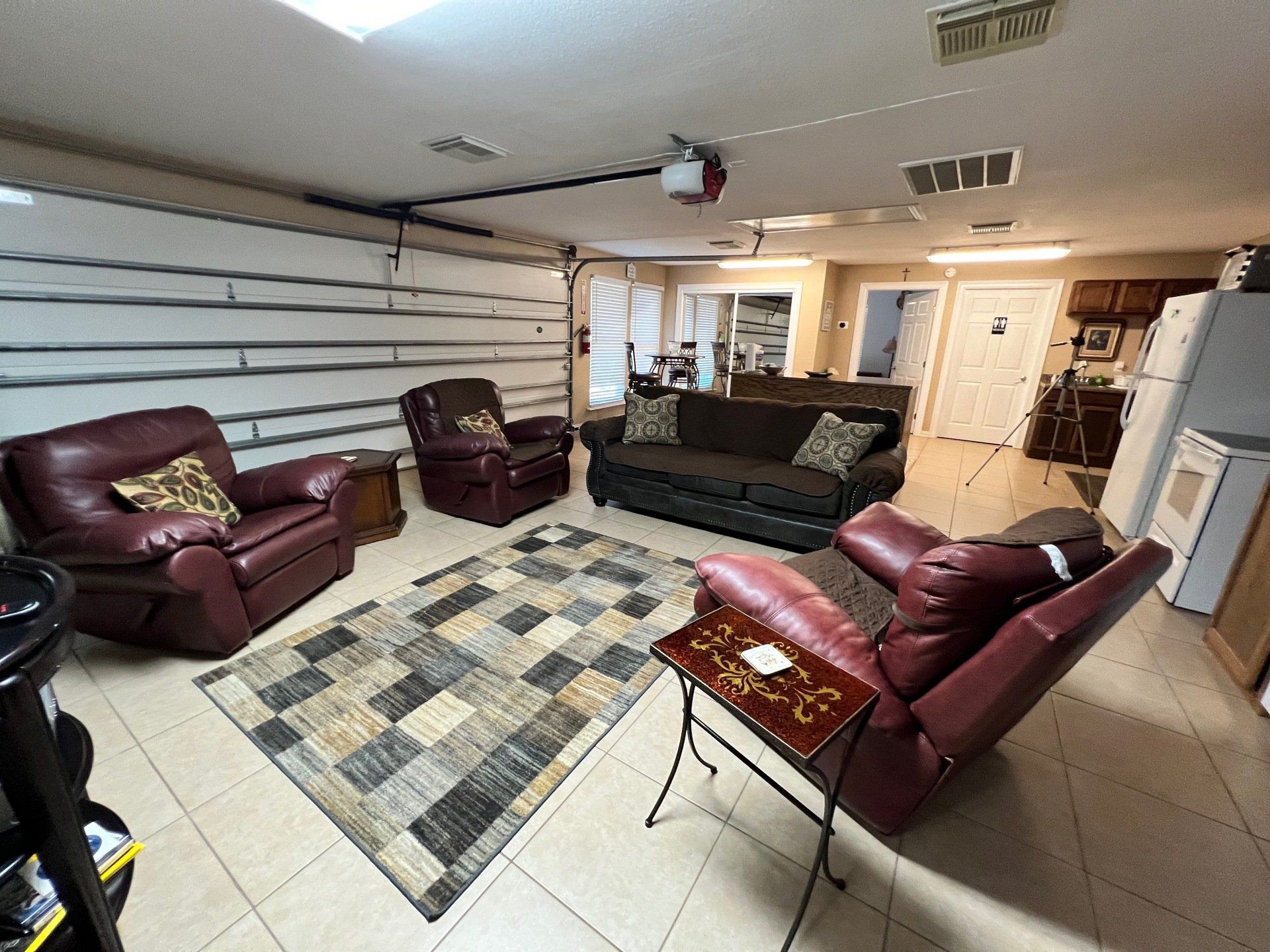 a living room with a couch , chairs , and a rug .