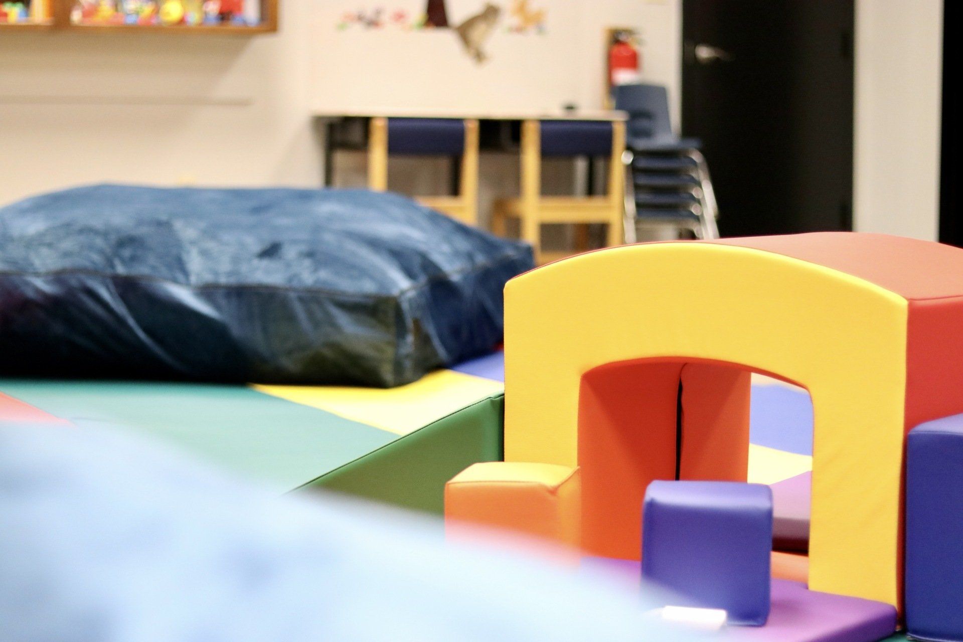 a room filled with colorful blocks and a blue pillow