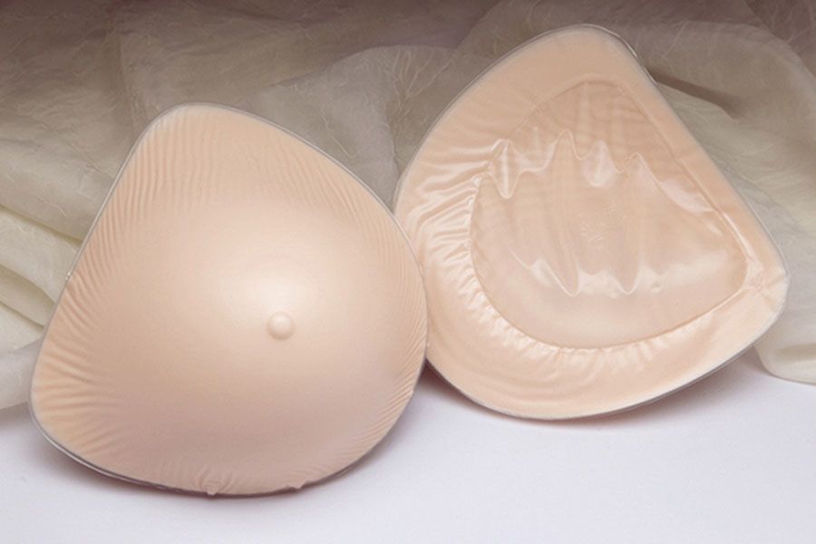 a pair of breast forms sitting on top of a white cloth .