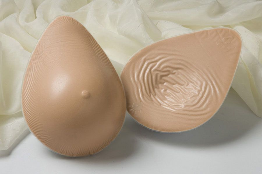 a pair of breast forms sitting on top of a white cloth .