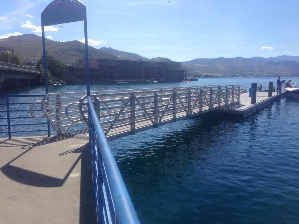 A dock overlooking a body of water with mountains in the background