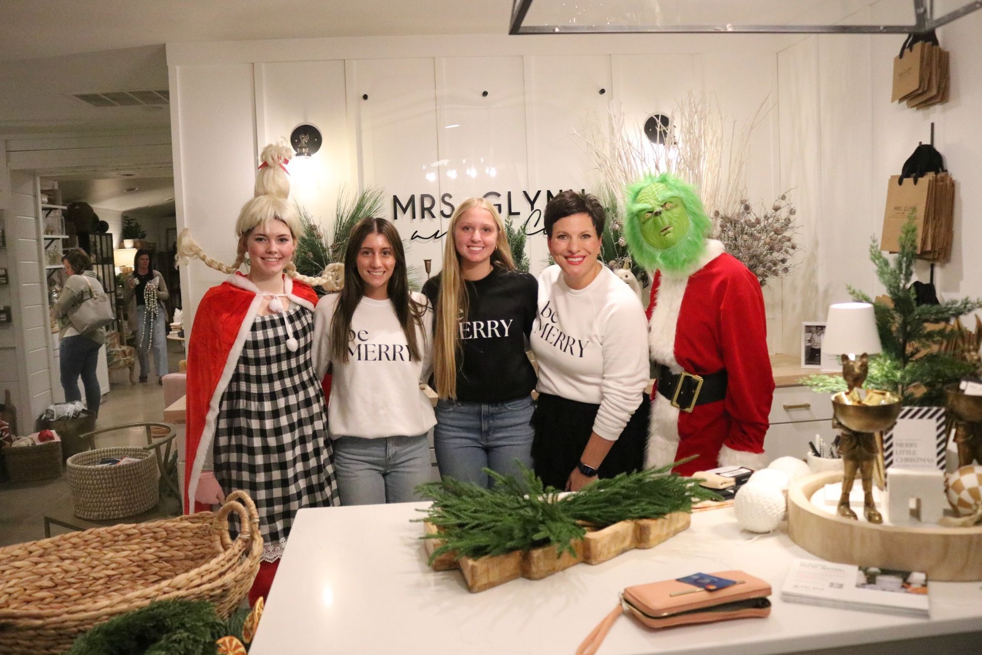 A group of women are posing for a picture in a room.
