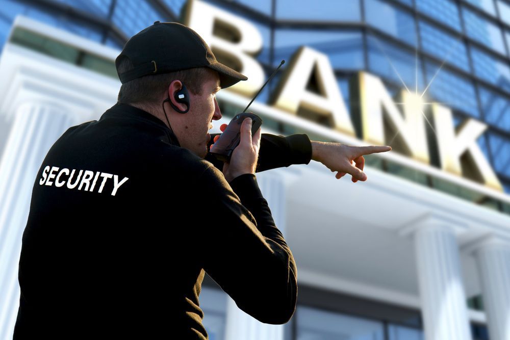 Security officer at the bank communicating via walkie-talkie — Alarm Monitoring in Moss Vale, NSW