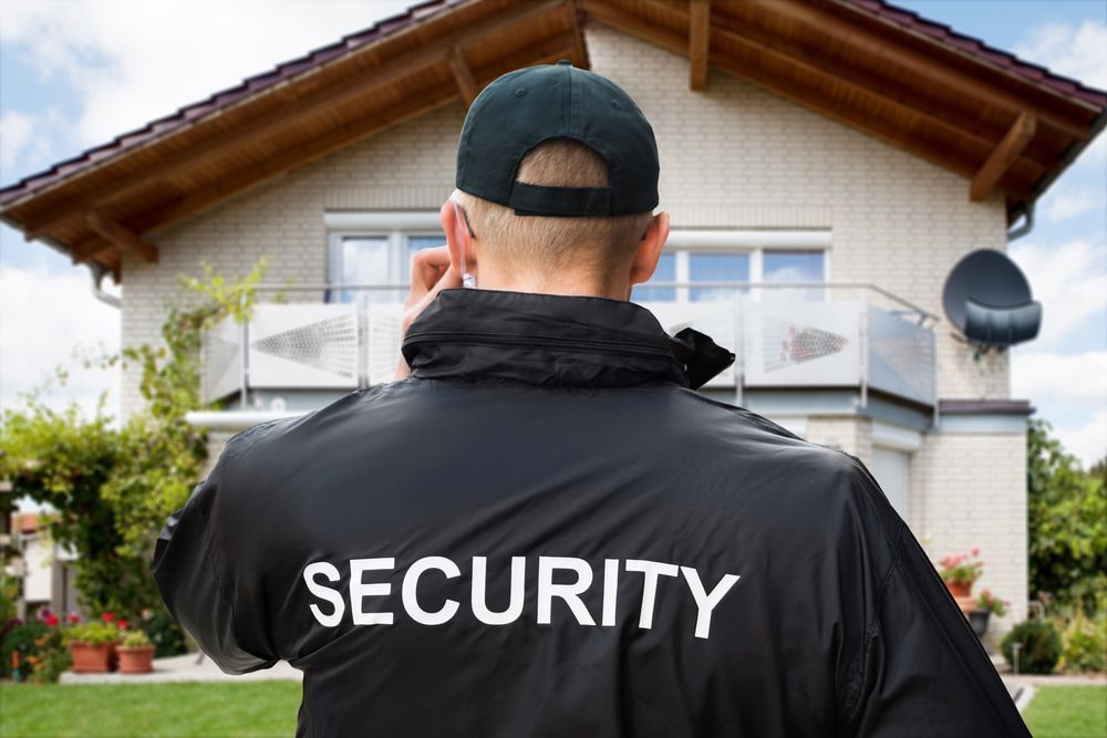 Security guard standing outside a house, providing vigilant protection — Security in Southern Highlands, NSW