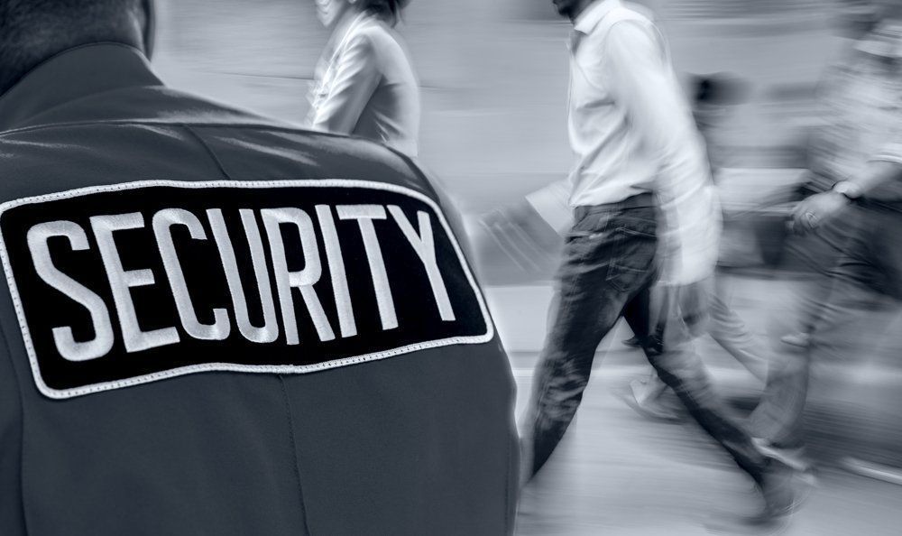 Conspicuous label inscription on the security guard's uniform — Security in Southern Highlands, NSW