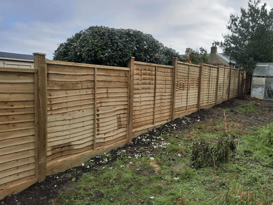 Long run of horizontal timber fence panels and posts along a garden boundary in Maidenhead.