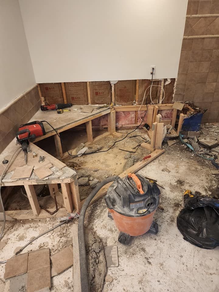A vacuum cleaner is sitting on the floor of a room under construction.