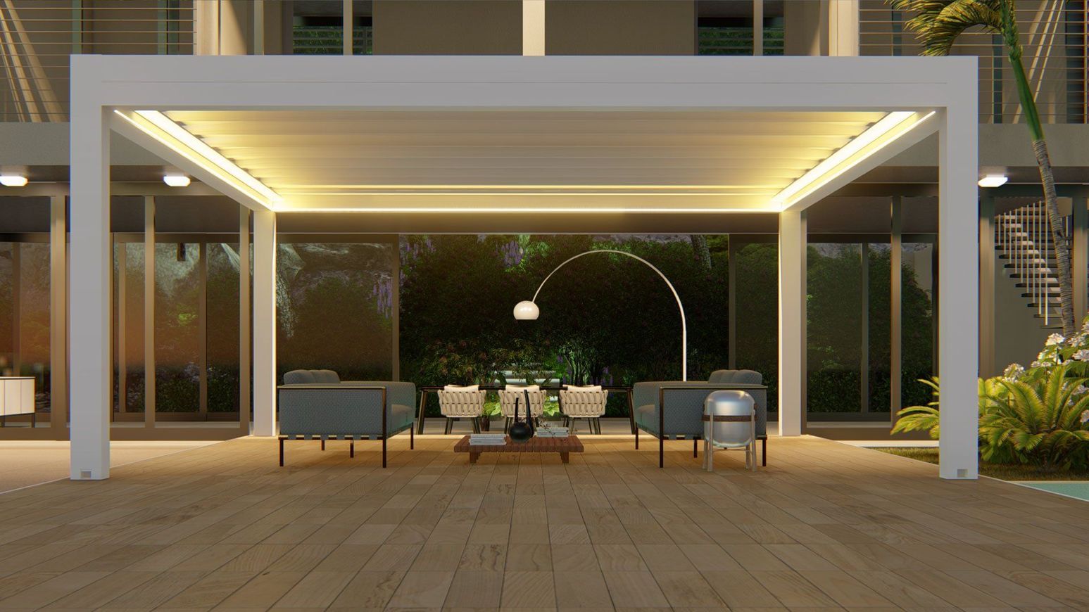 Patio moderno con sedute imbottite sotto un pergolato illuminato di notte.