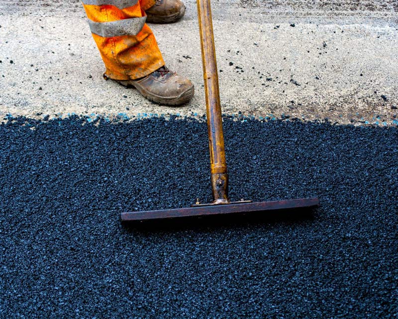 Worker Repairing Road Street — Bitumen Services in Darwin, NT