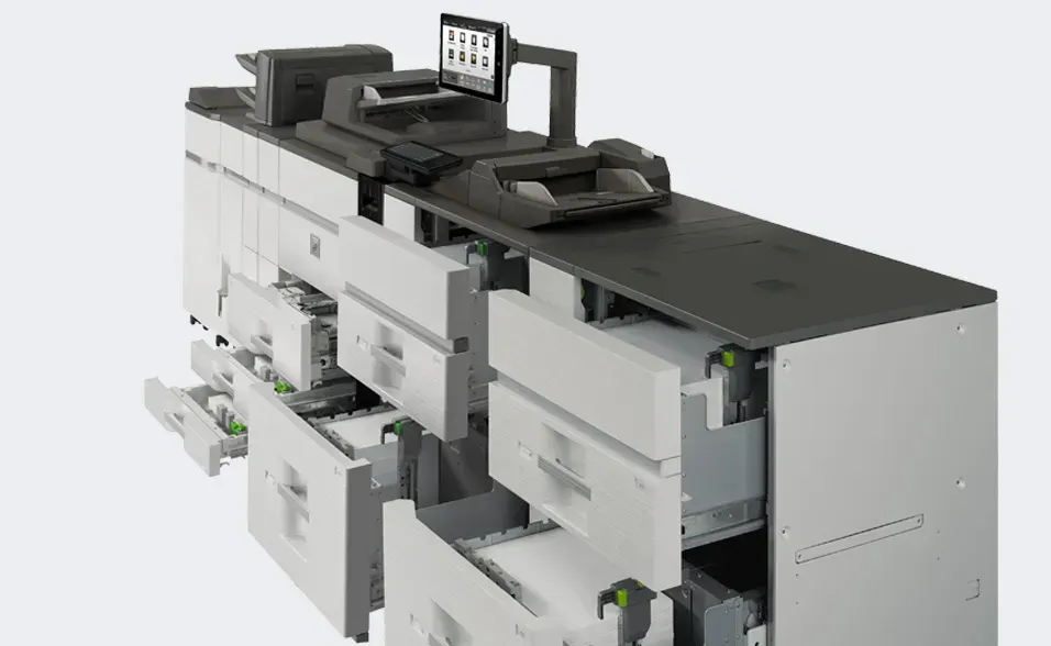 Large industrial printer with open paper trays, a control panel, and a monitor.