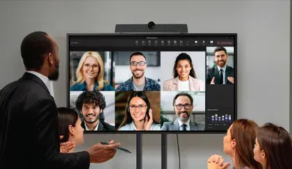 People in a meeting room watching a video conference on a large display, with Digital Signage Awards 2024 Finalist logo.