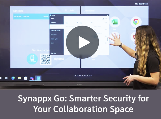 Woman points at interactive display showcasing Synappx Go features; collaboration space security.