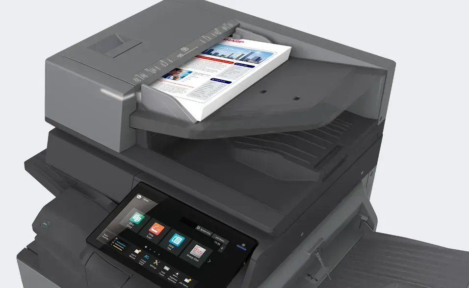 Multifunction printer with paper in feeder and touchscreen control panel.