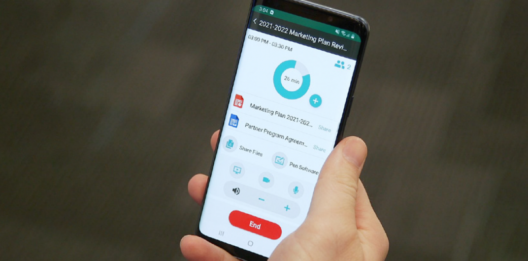 Hand holding a smartphone displaying an app interface with usage data and a red 