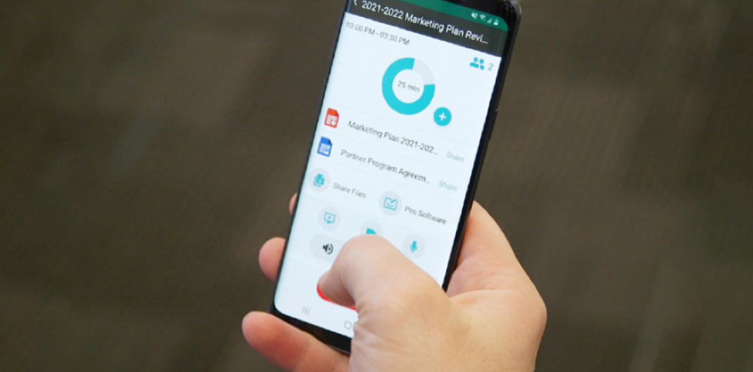 Hand holding a smartphone displaying a data usage app; finger touching the screen.