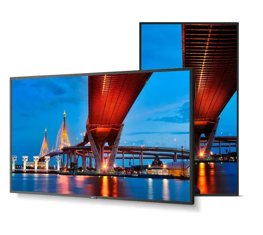 Two flat-screen TVs showing a night bridge scene with bright blue sky and red-lit underside of the overpass