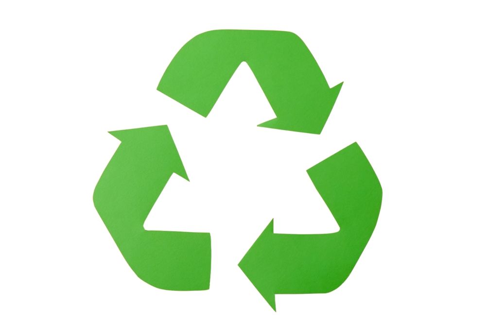 Green recycling symbol with three arrows in a circular formation, indicating reusable resources.