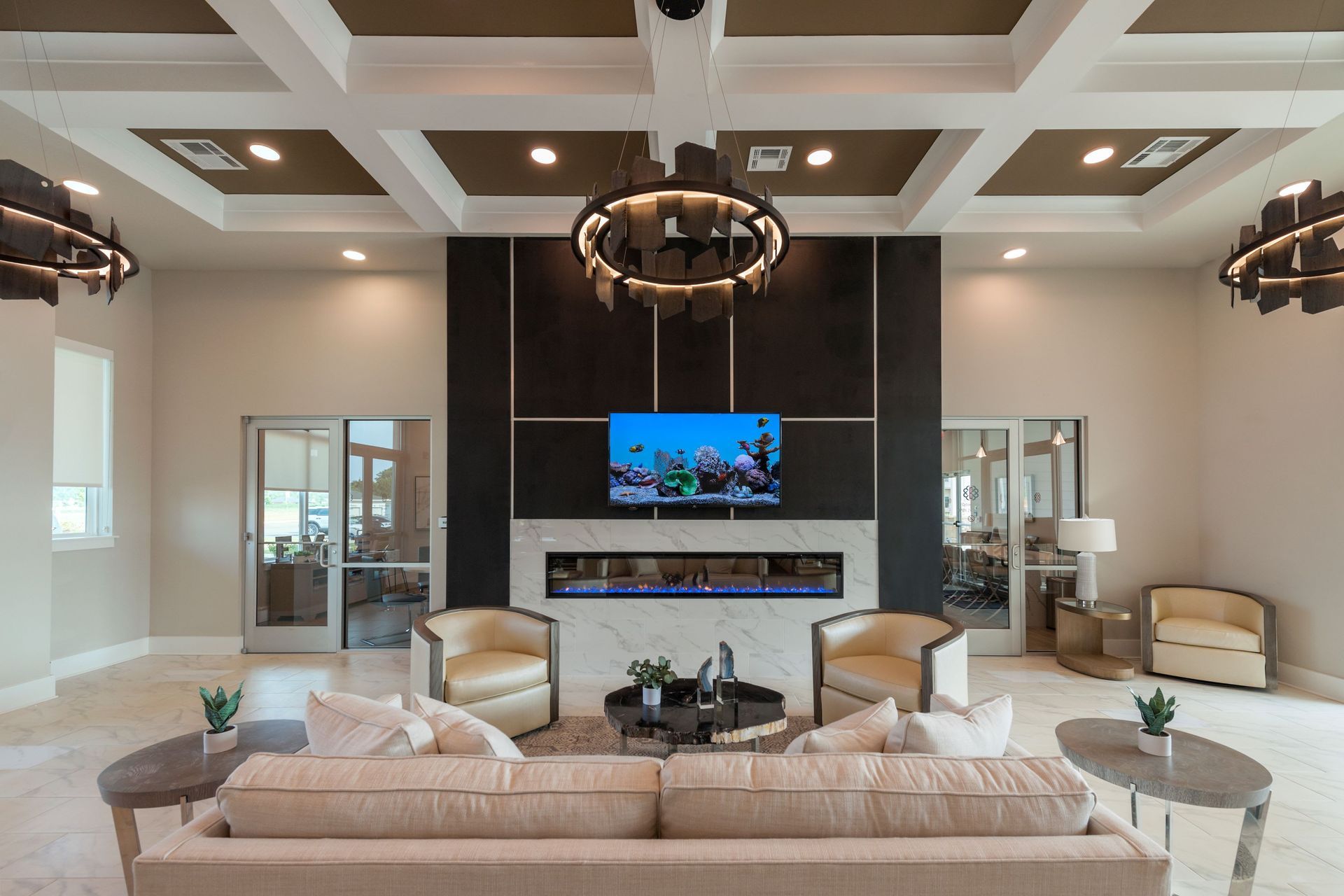 Luxurious lounge area with fireplace, TV, seating, and decorative lighting.