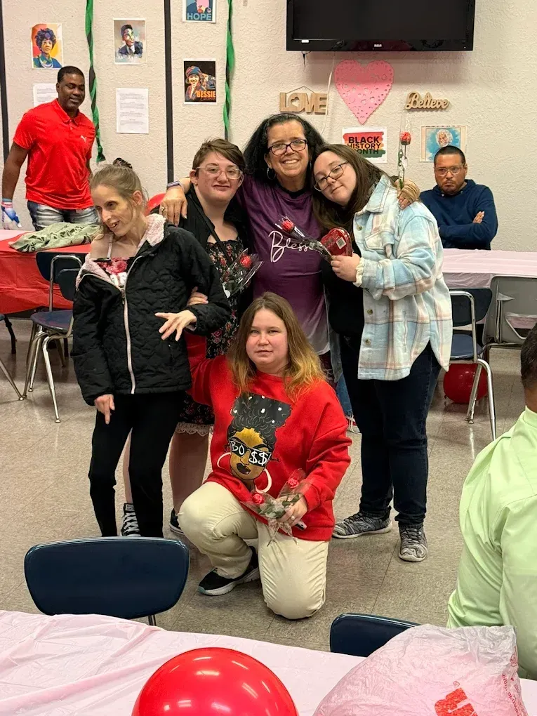 A group of people are posing for a picture in a room.