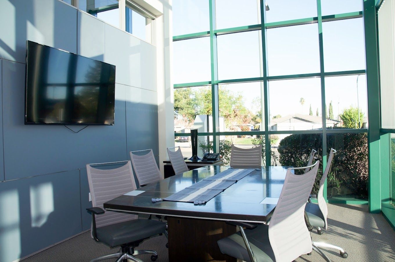 Conference room with floor-to-ceiling windows at 1900 Camden Ave