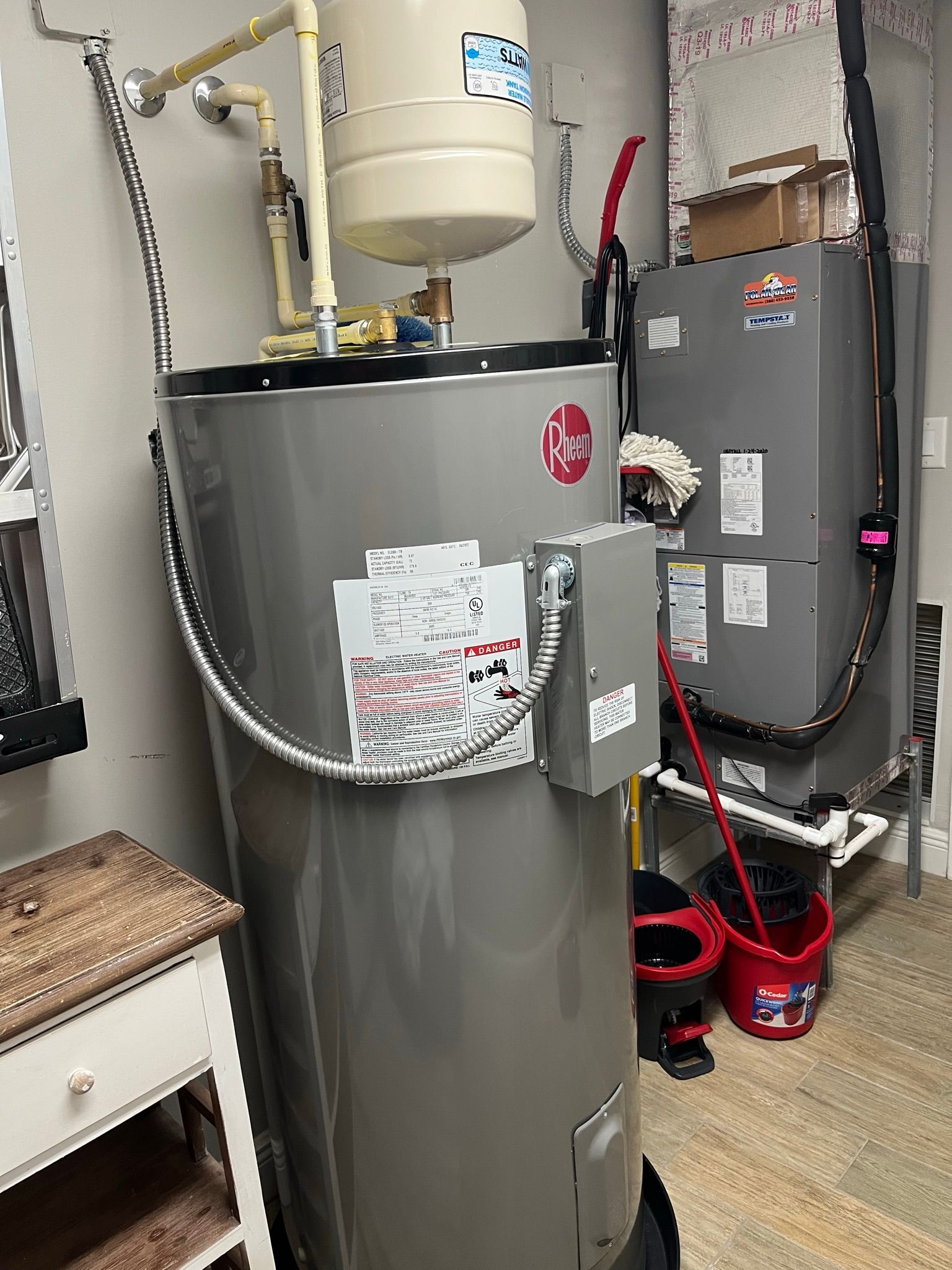 Water heater with copper pipes and fittings in a utility closet