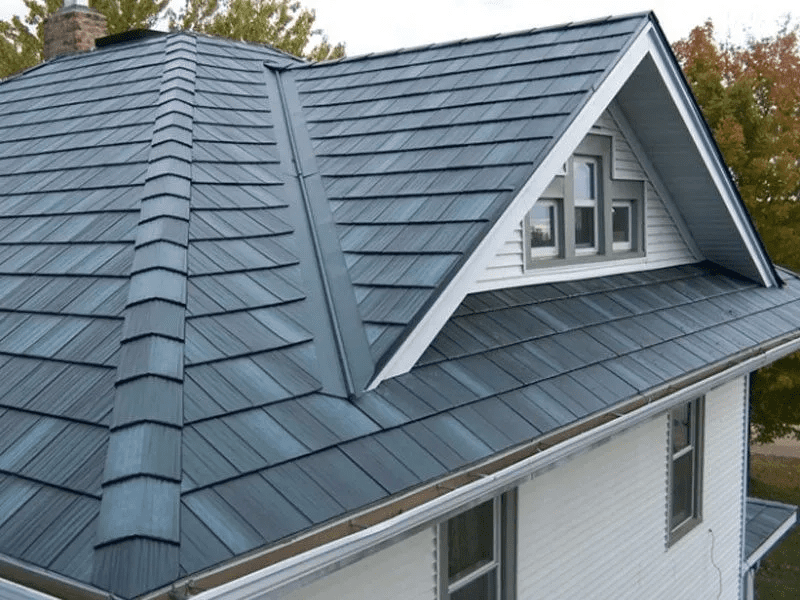 Gray metal roof with dormer windows on a house, viewed from above