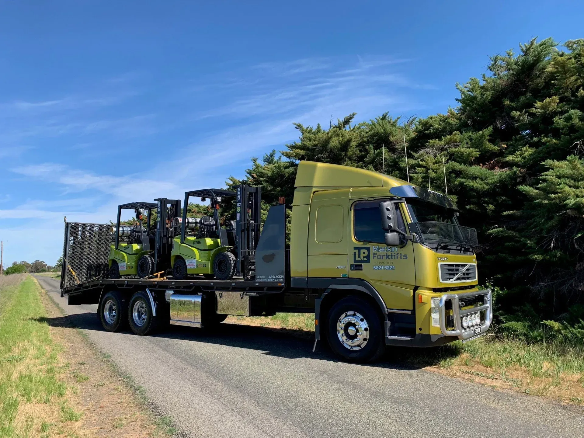 A Man Is Driving a Forklift in a Warehouse Carrying a Pallet of Cans | Shepperton, VIC | L&P Mackin Forklifts
