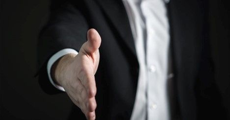 Man In A Suit Extending His Hand For A Handshake - Parker, CO - Backstop Coaching Man In A Suit Extending His Hand For A Handshake - Parker, CO - Backstop Coaching