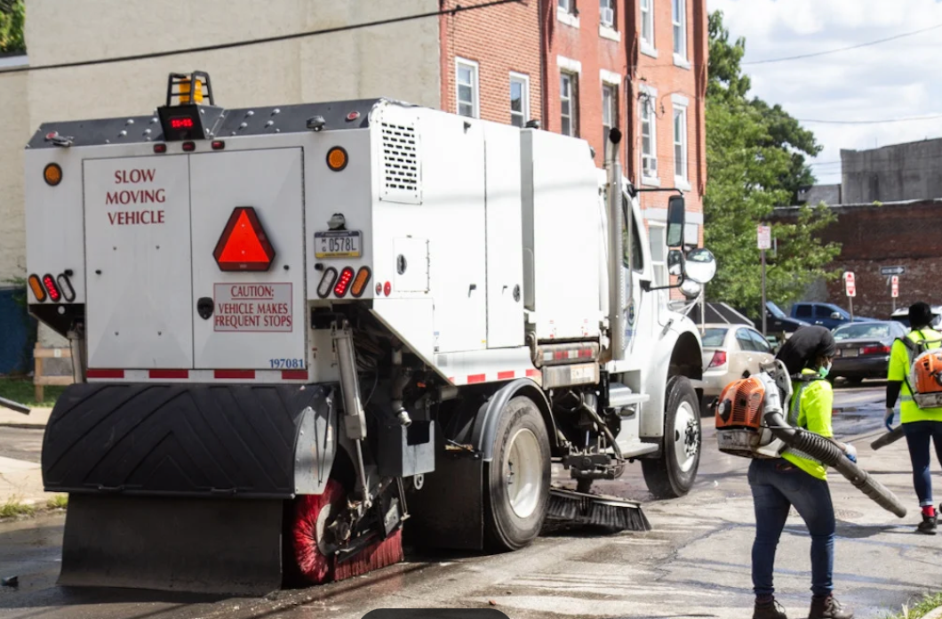 A parking lot sweeping truck in Nebraska cleaning a commercial parking lot and removing debris.