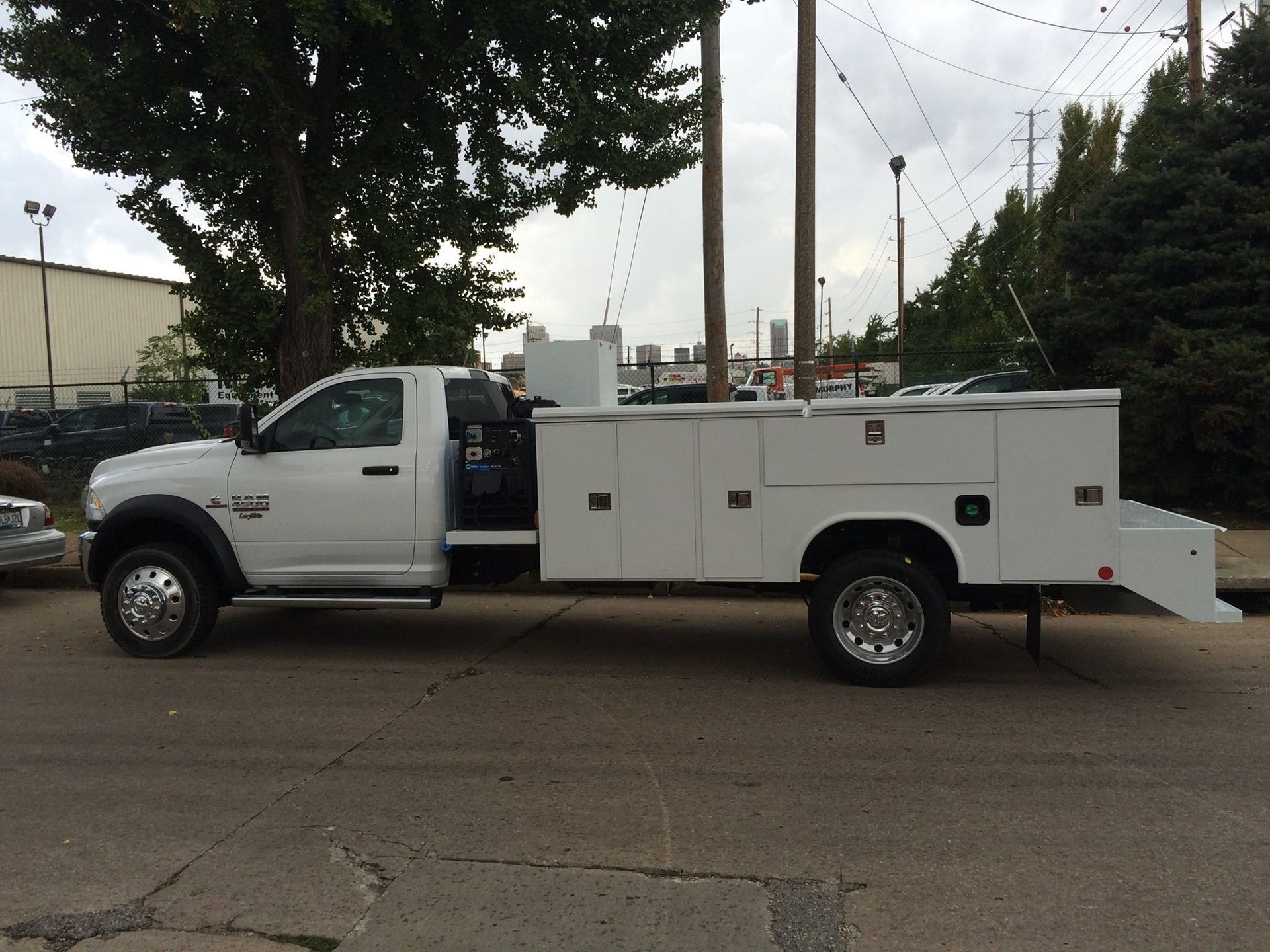 White Ram 5500 service truck with a large utility bed parked on a street.