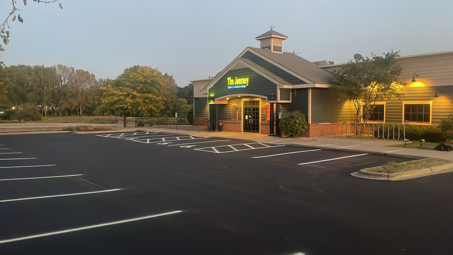 Exterior of The Tavern restaurant in a parking lot on a sunny day.