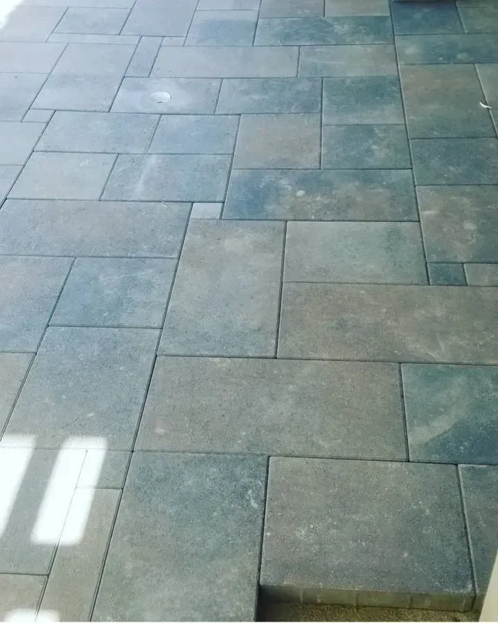 Gray paving stones in a patio layout, with varying rectangular sizes and patterns.