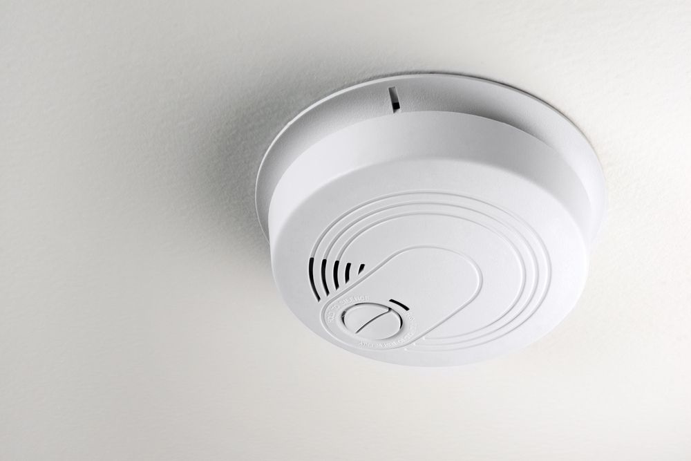 White Smoke Detector Mounted on a White Ceiling — Jade Fluerty Electrical In Tinana, QLD