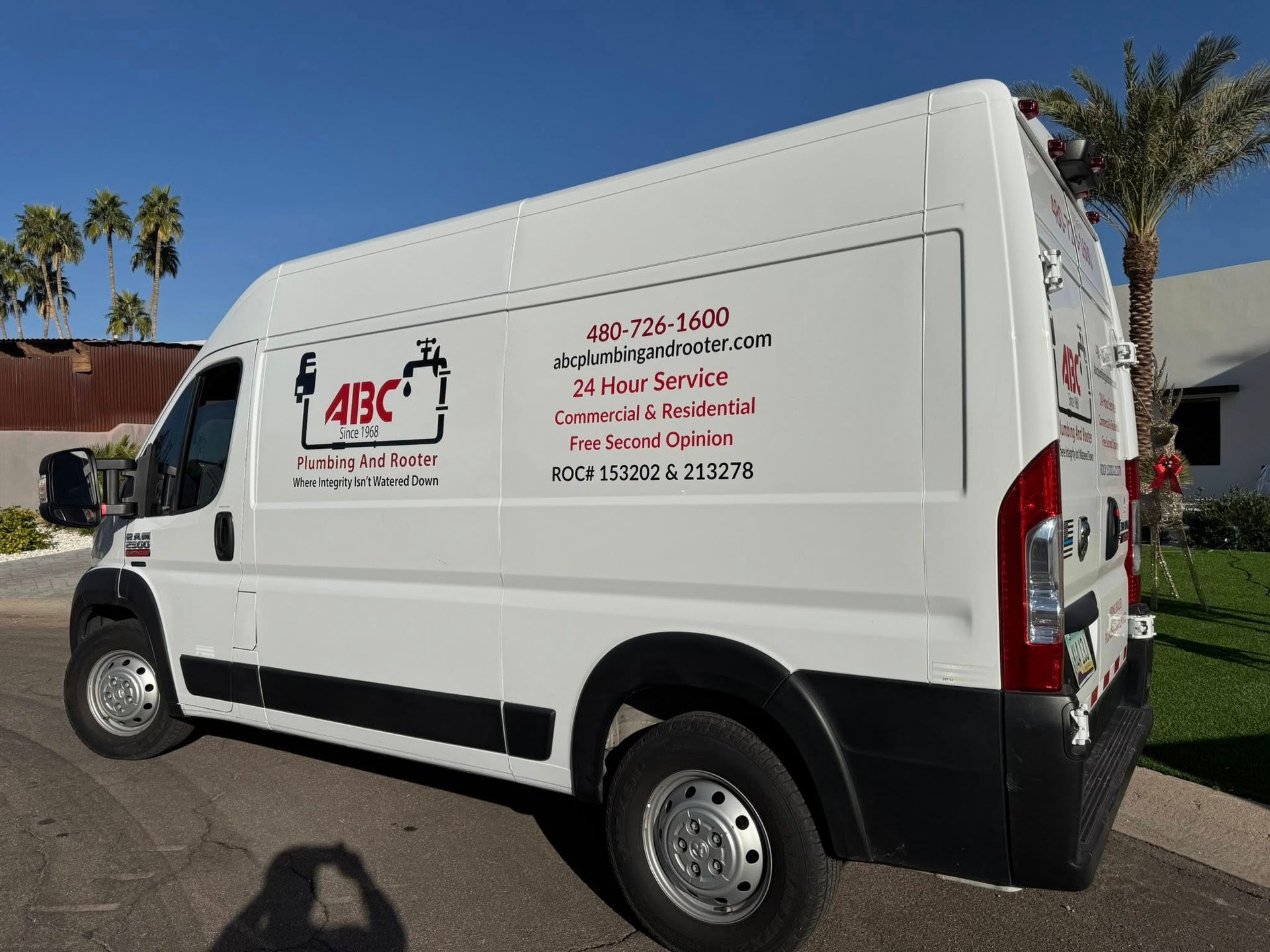 A white plumbing service van branded with 