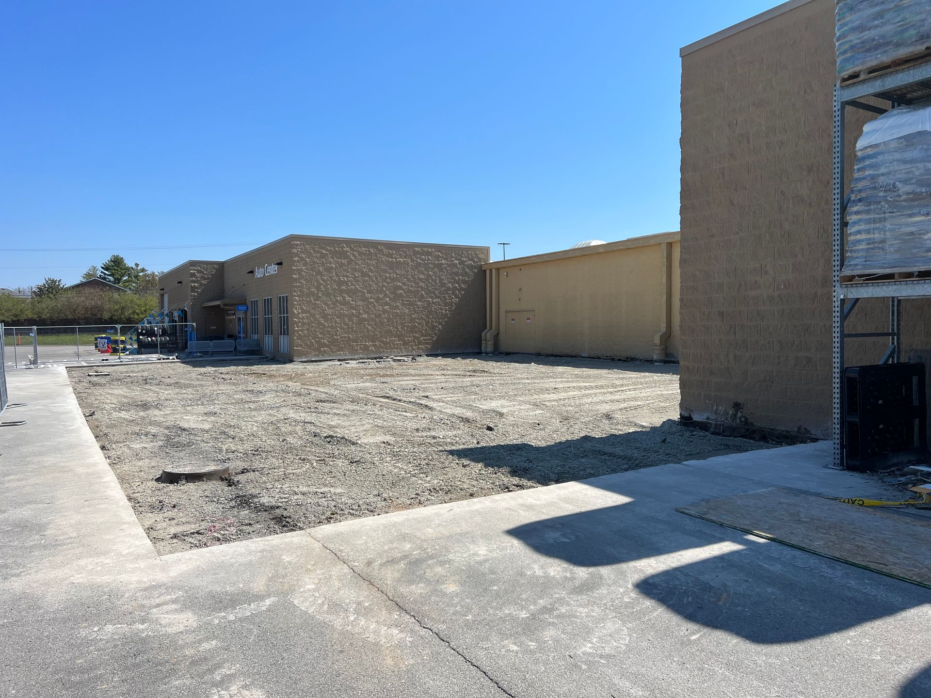 A building under construction with a lot of dirt in front of it