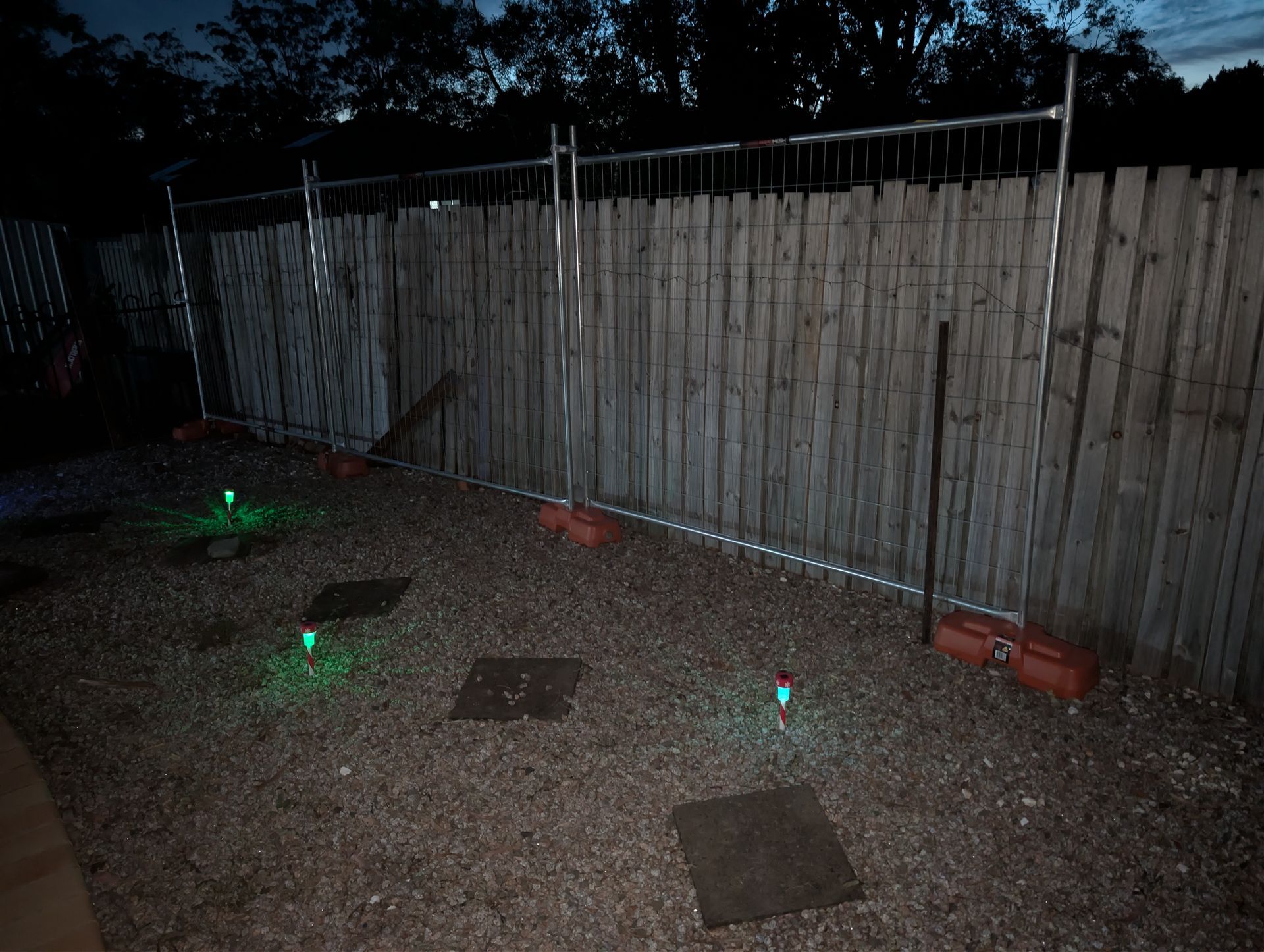 Nighttime Backyard With Gravel Path, Wooden Fence — Tuff Fencing in Caboolture, QLD