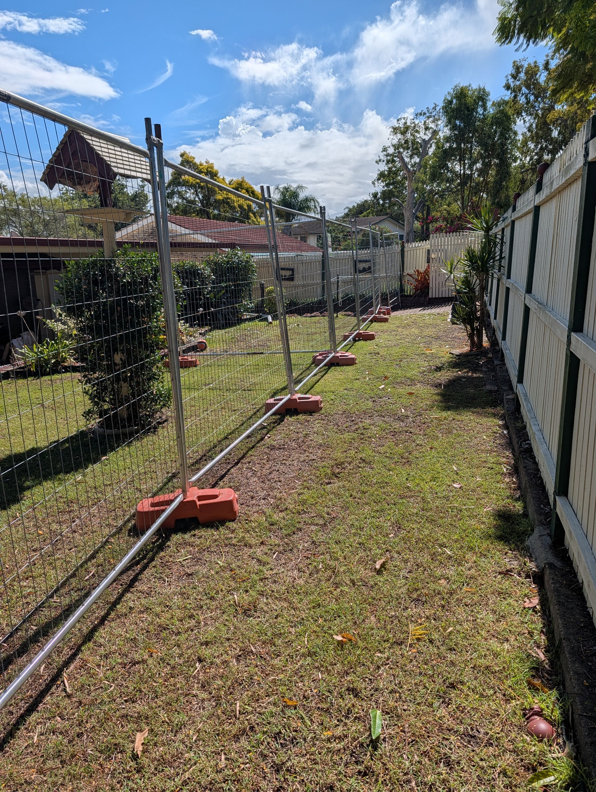 Narrow Grassy Side Yard With a Chain-link Fence, and Leaning Posts — Tuff Fencing in Caboolture, QLD