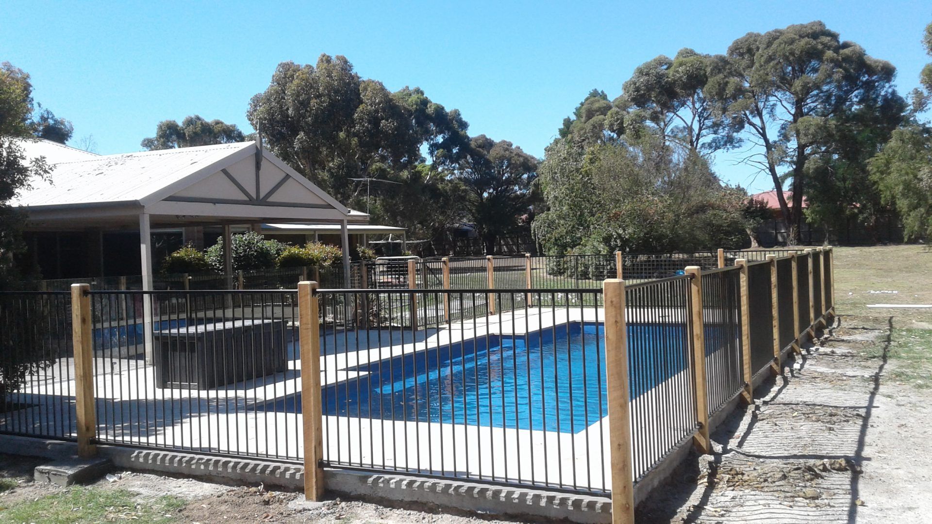 A Wooden Retaning Wall next to a Canal  — Tuff Fencing in Caboolture, QLD