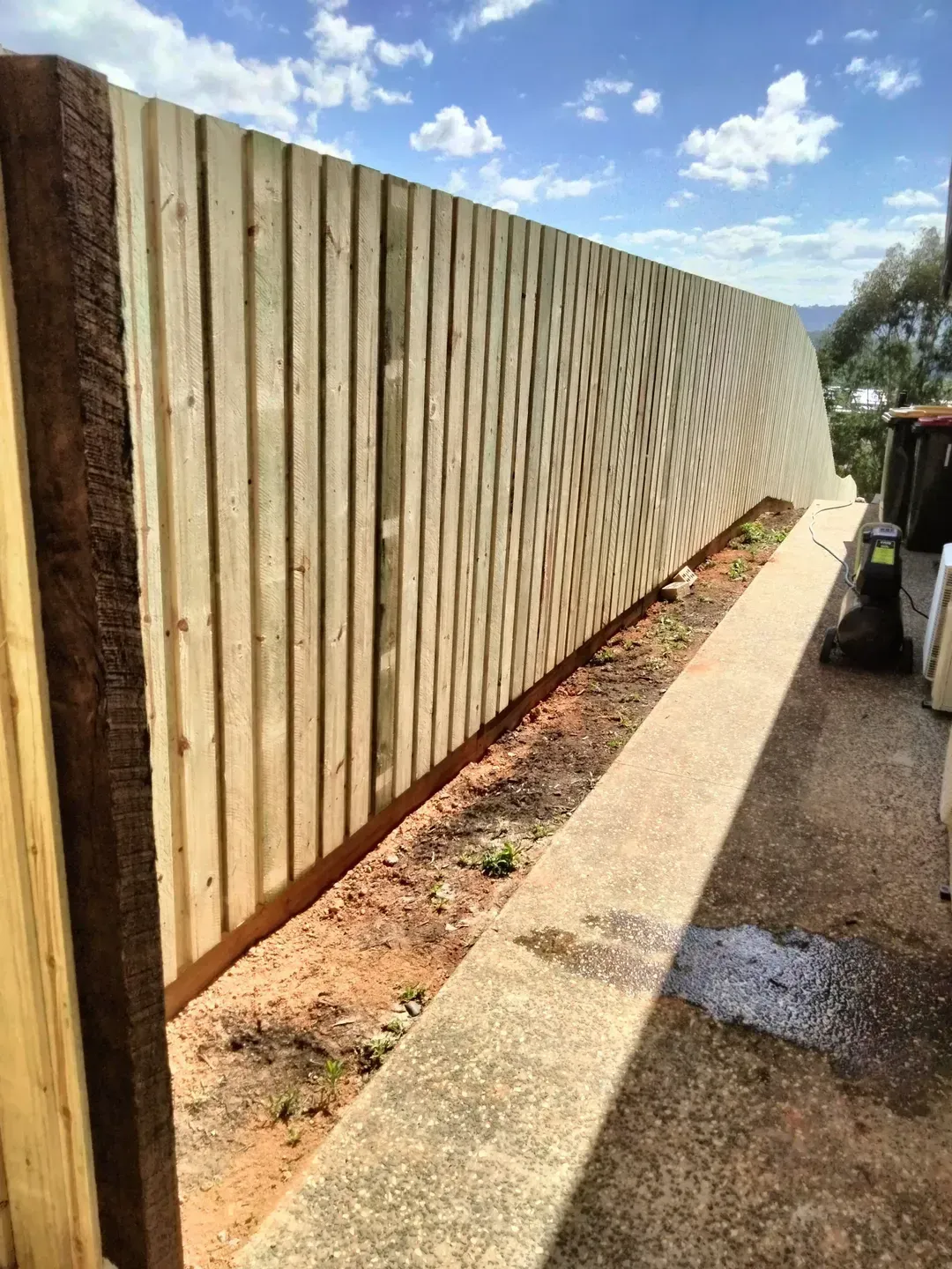 A Wooden Slat Fence next to Concrete Path — Tuff Fencing in Caboolture, QLD