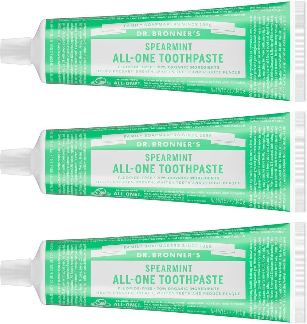 Three green tubes of Dr. Bronner’s Spearmint All-One Toothpaste stacked vertically