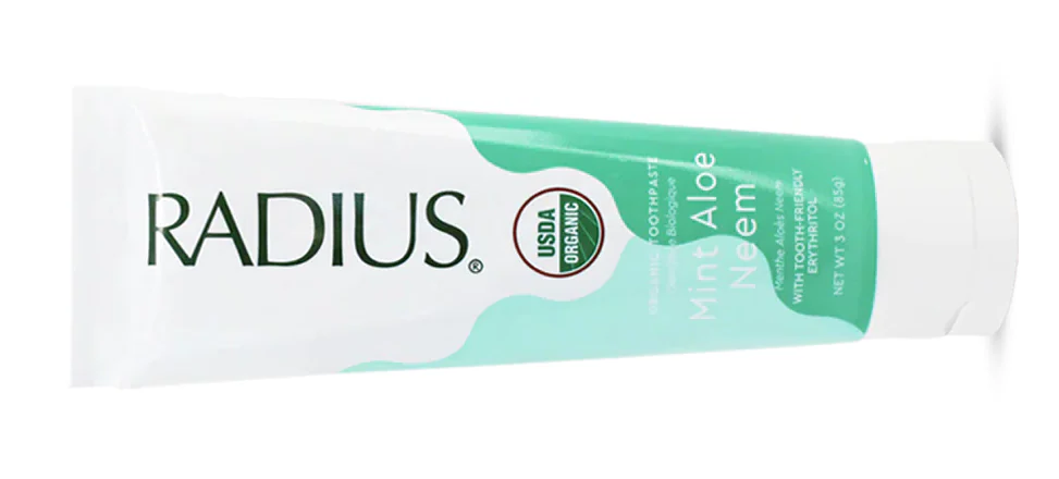 White and teal RADIUS Aloe Mint toothpaste tube on a white background