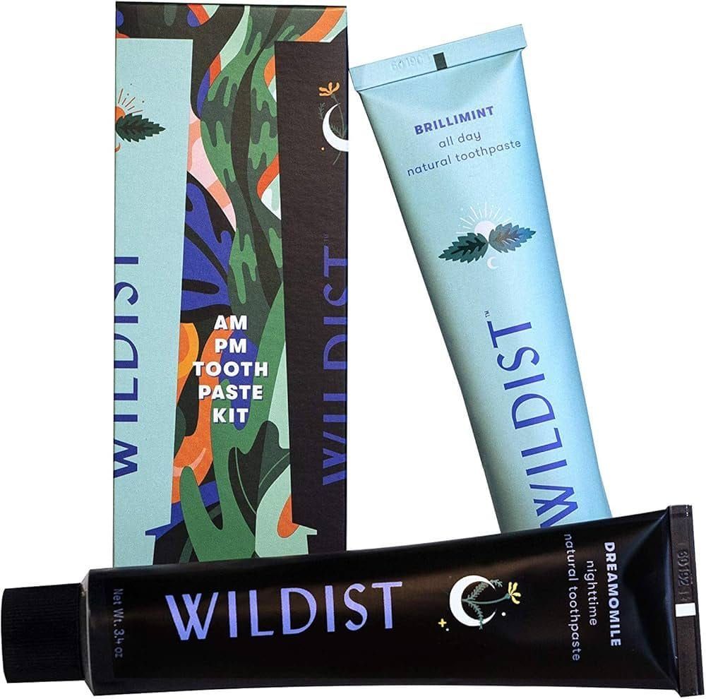 Wildist toothpaste kit with black tube, blue tube, and patterned box on a white background